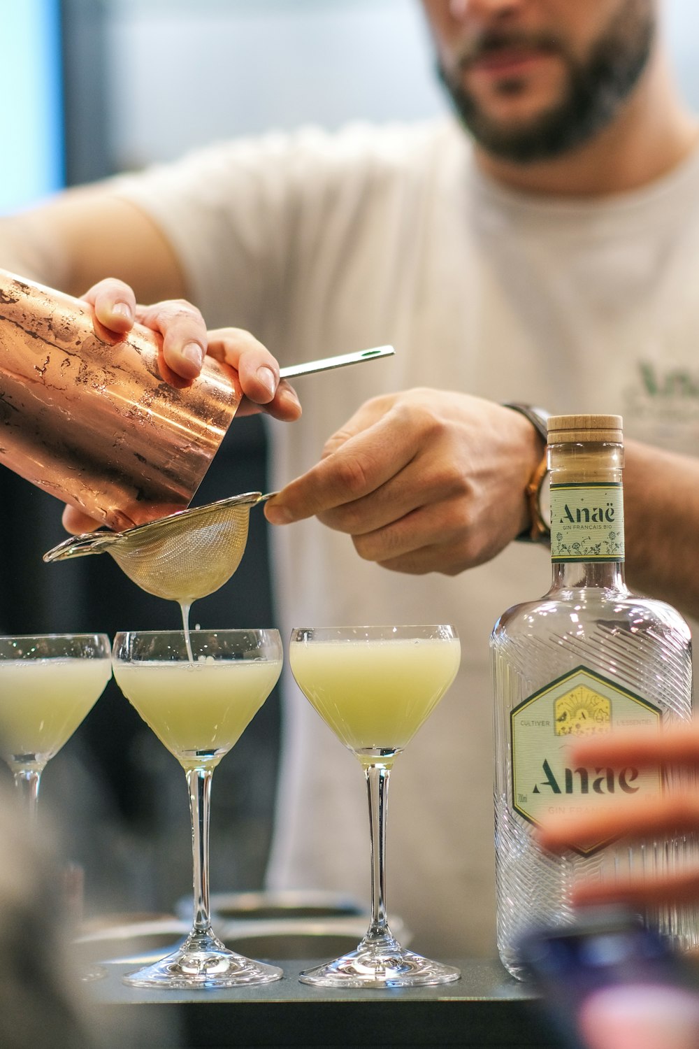 a man is making a drink at a bar