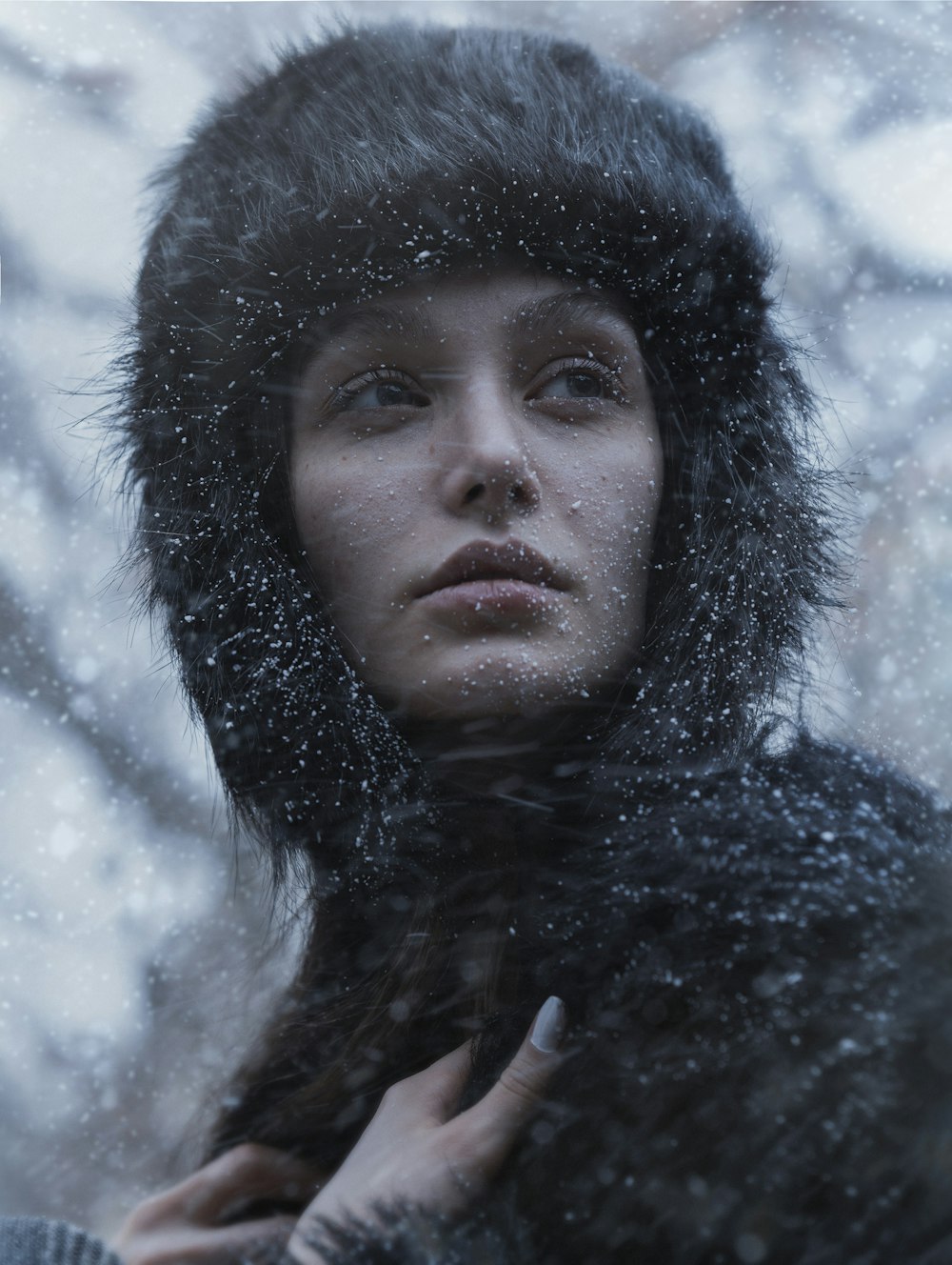 a woman wearing a fur hat in the snow