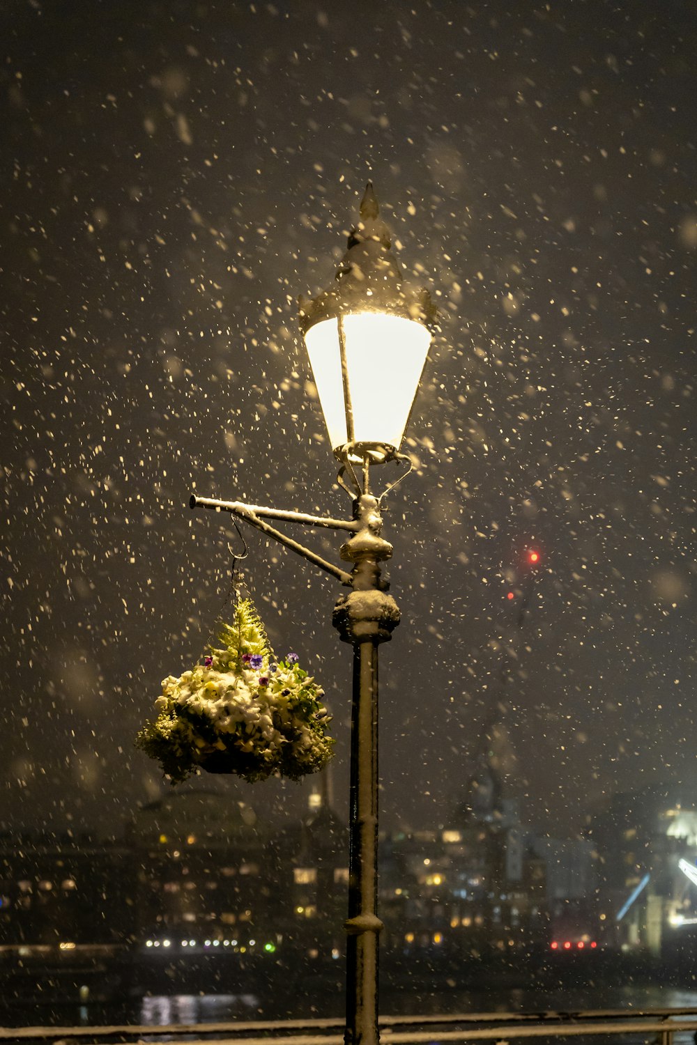 a lamp post with a bunch of flowers on it