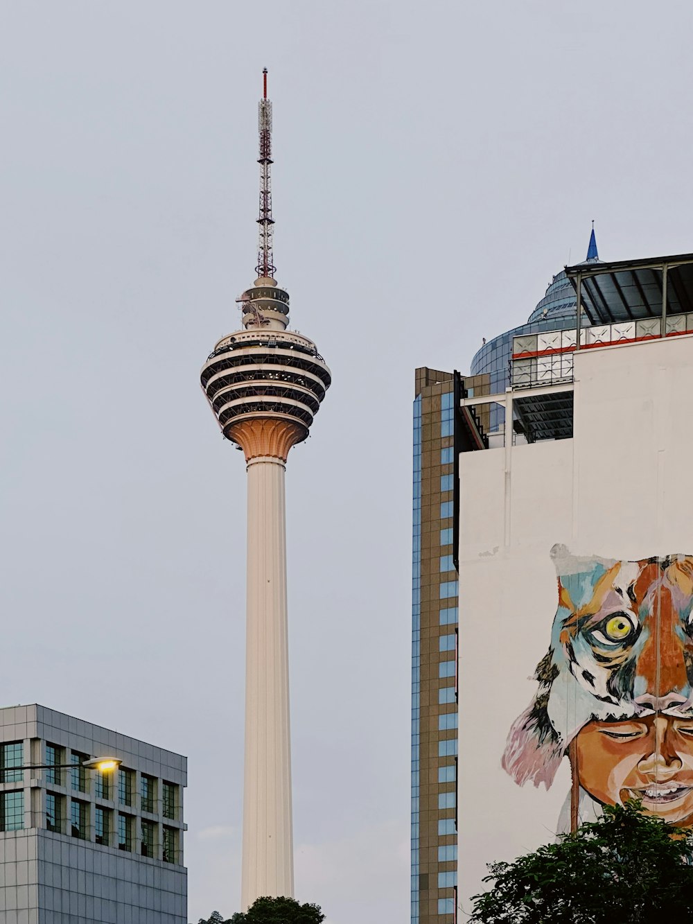 a tall building with a very tall tower next to it