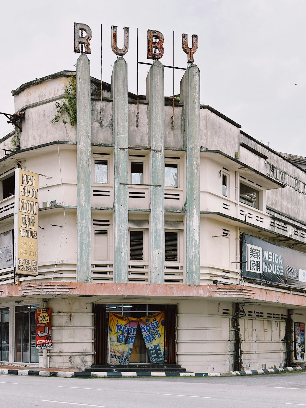 a run down building with a bunch of signs on top of it