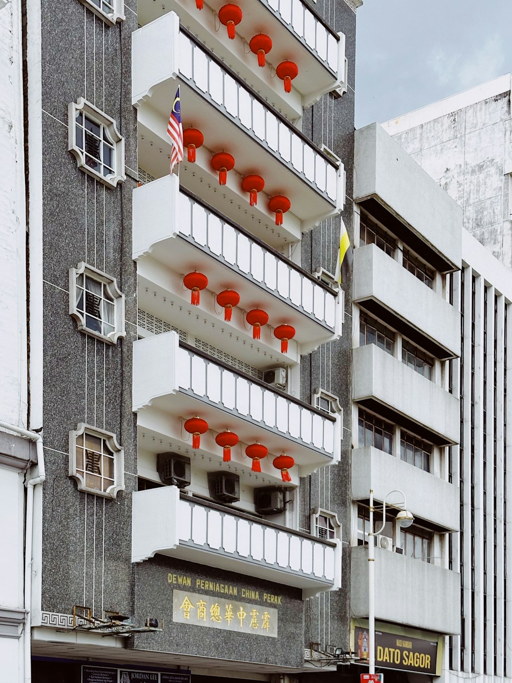 a tall building with many balconies on top of it