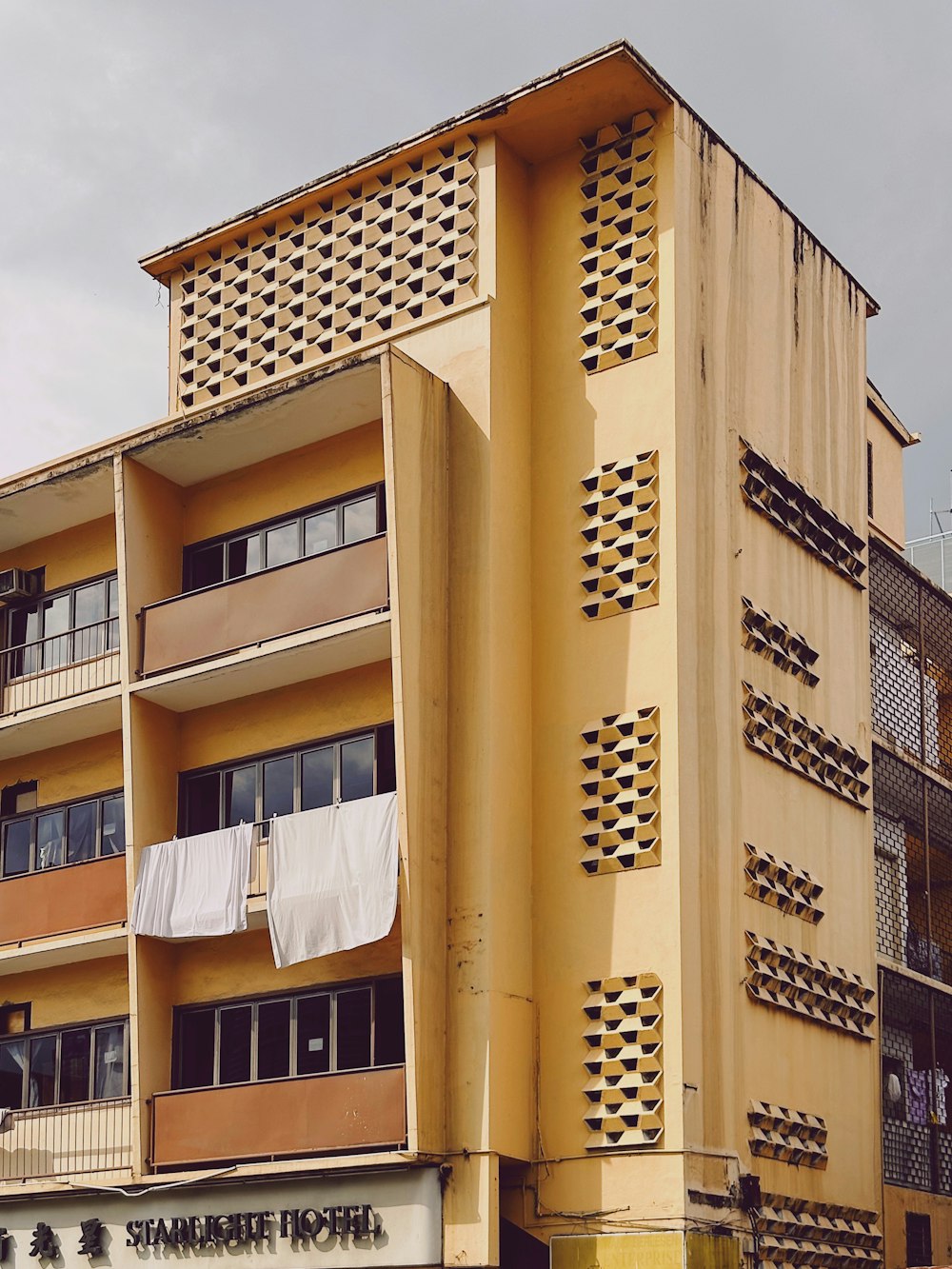 a building with a lot of windows and a laundry line on the outside of it