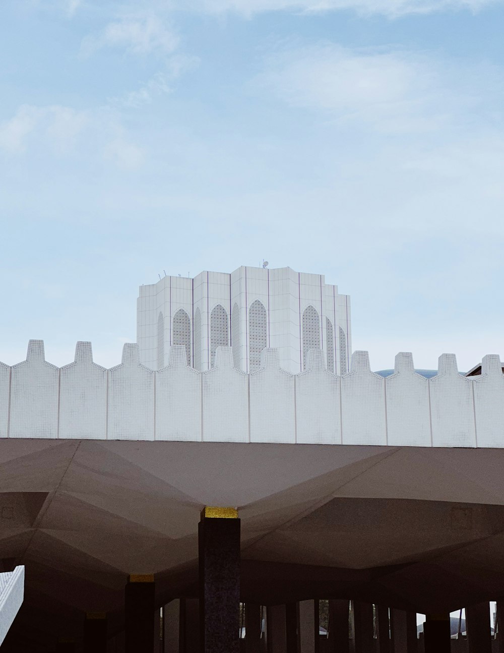 a large white building sitting on top of a bridge