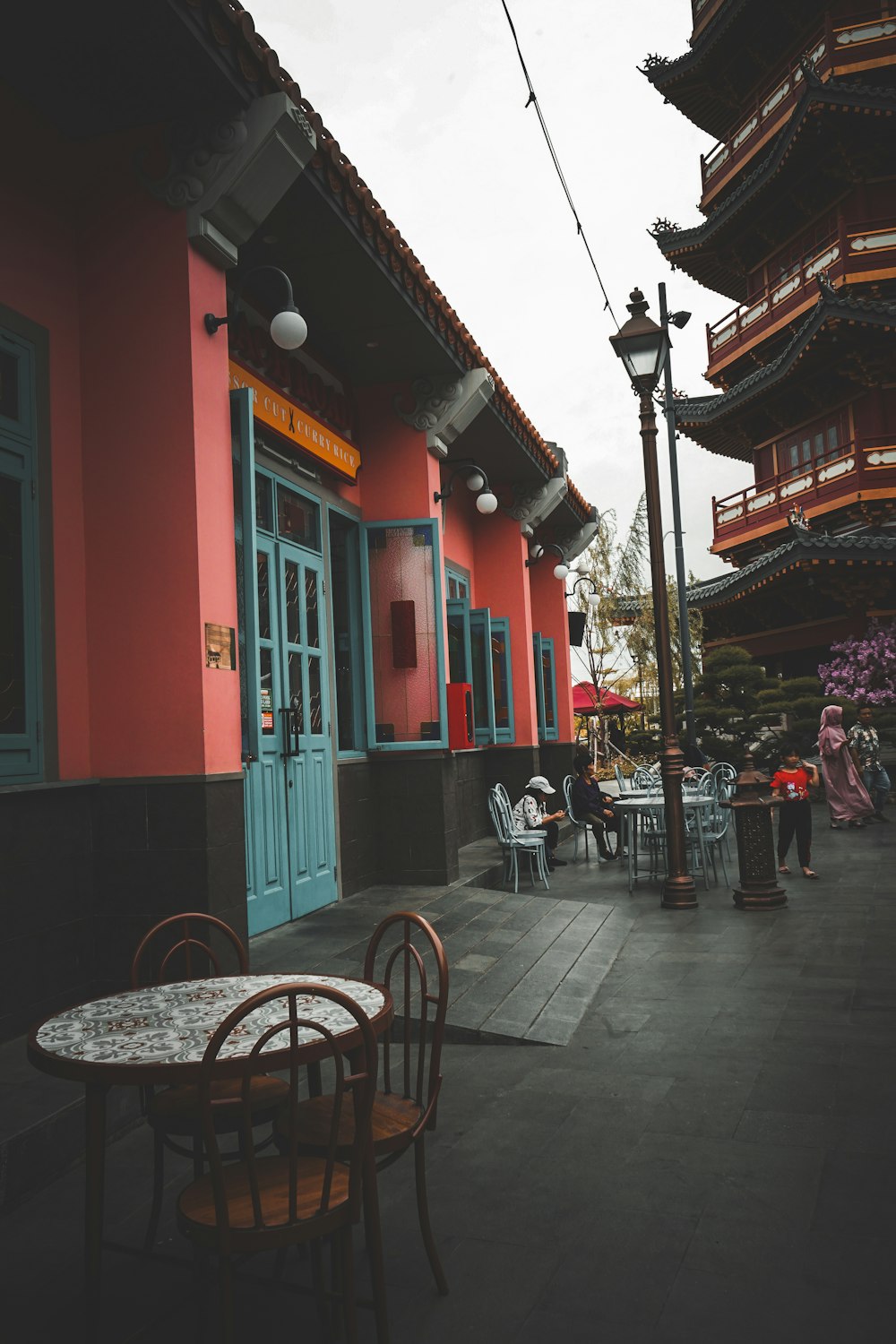 a group of people sitting at a table outside of a building