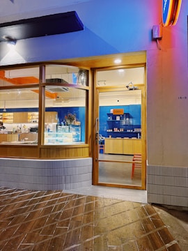 A sleek modern website homepage for a local coffee shop designed with blue and orange accents.