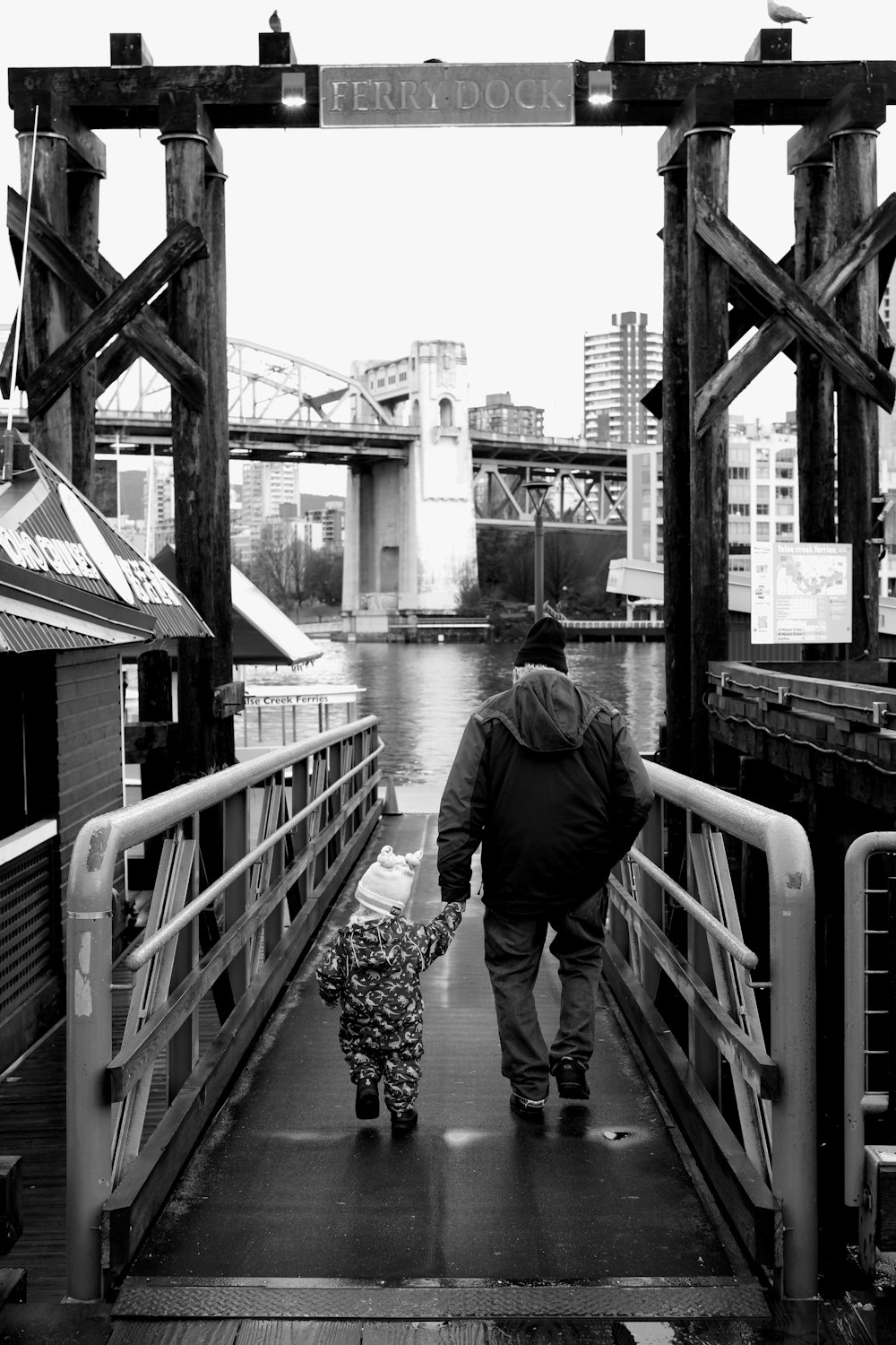 a man walking down a bridge with a child