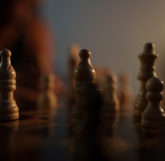 a close up of a chess board with a person in the background