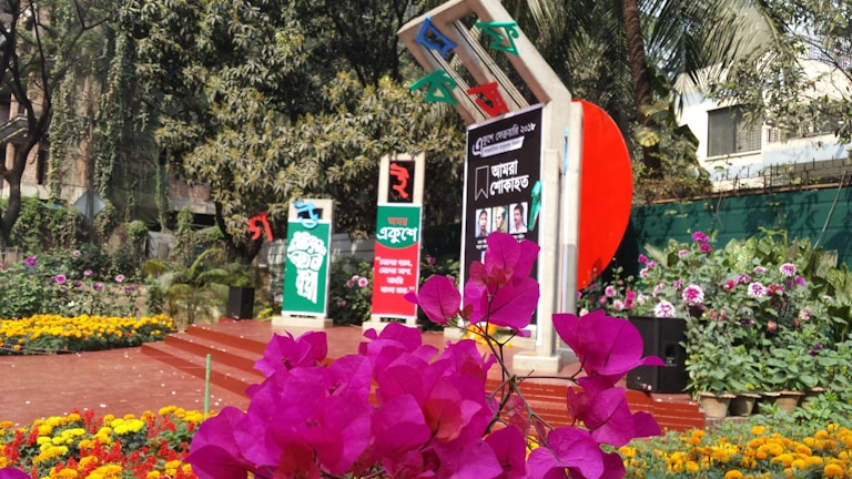 Close-up of a vibrant garden design blending colorful flowers with sleek graphic signage.