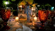 A beautifully arranged dining table outdoors with gourmet dishes and wine.