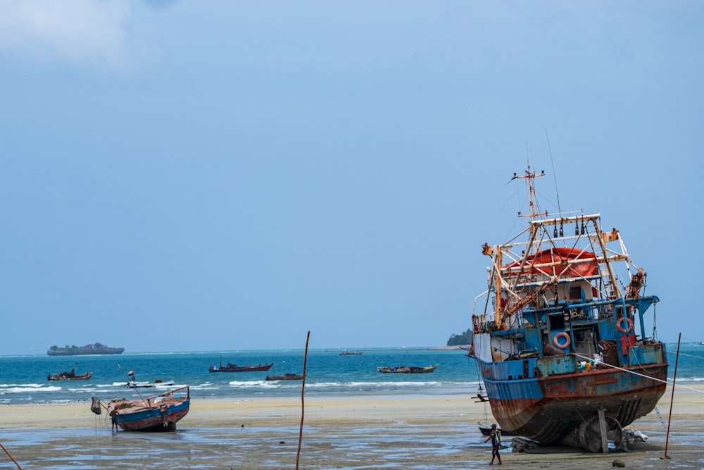 a couple of boats that are sitting in the sand