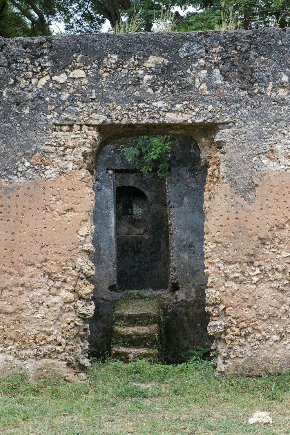 a stone building with a door and steps leading to it