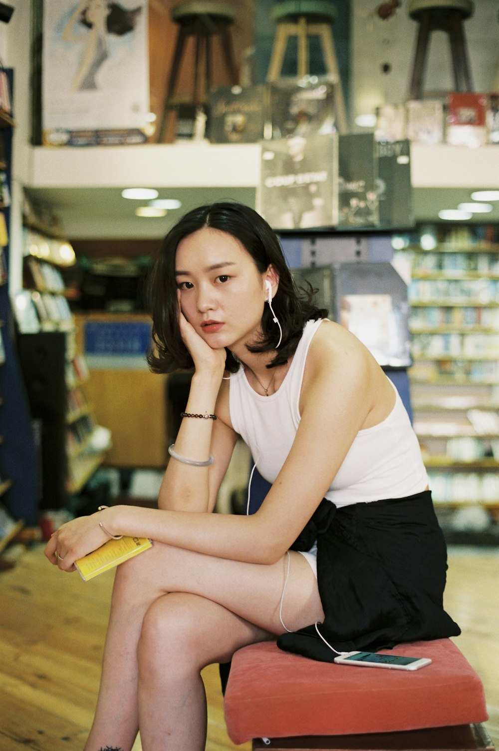 a woman sitting on a bench in a store