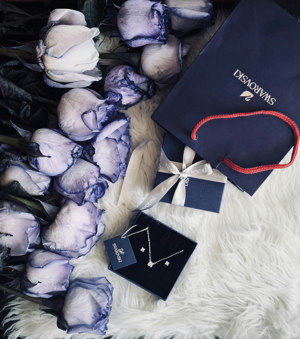 a graduation cap and a pair of earrings on a fur rug