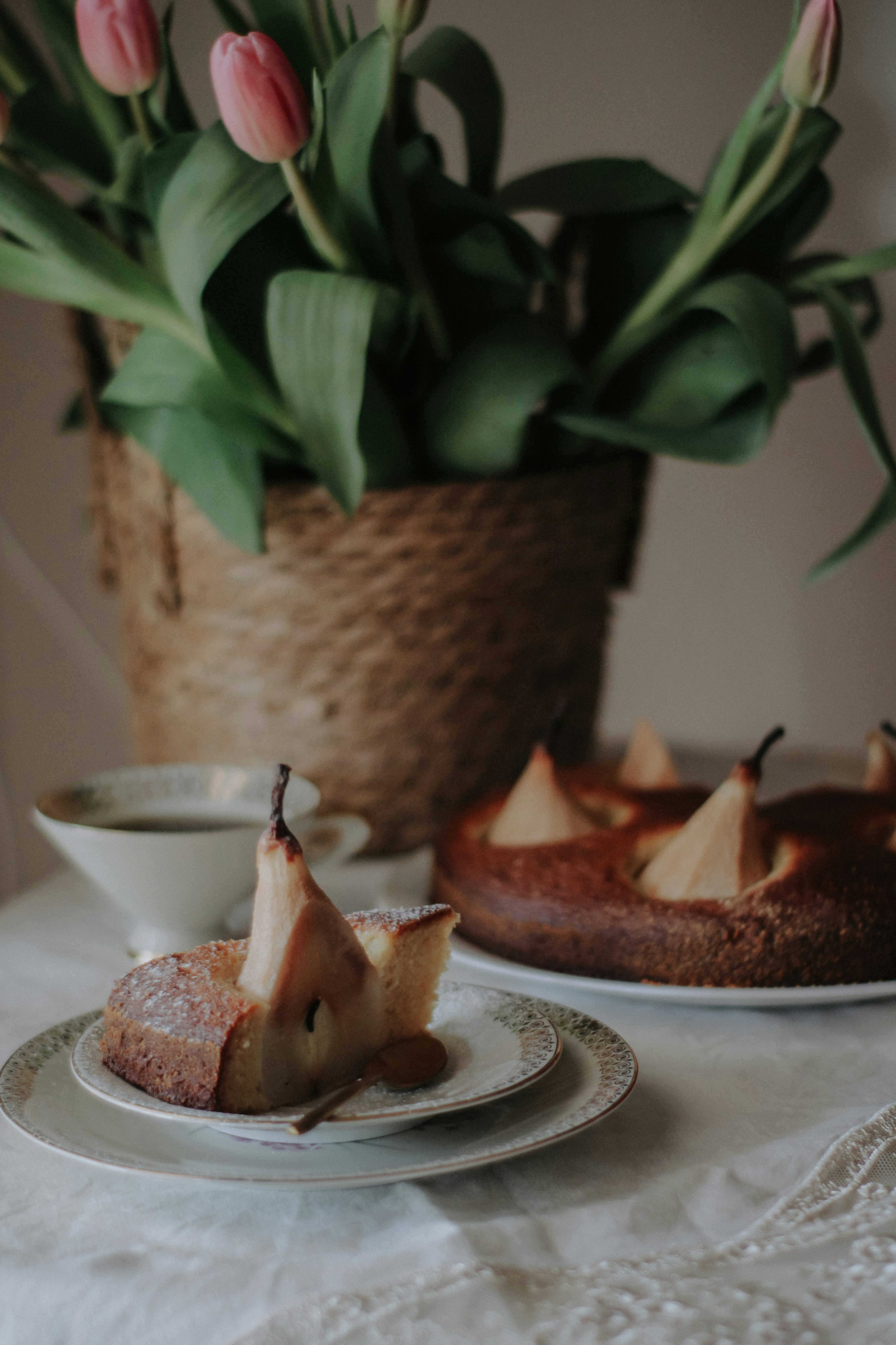 a table topped with two plates of food and a potted plant