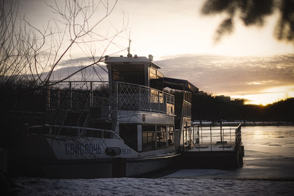 a boat is docked on the water at sunset