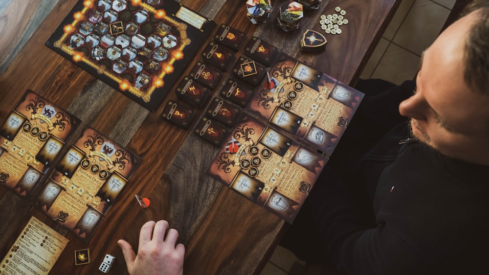 a man sitting at a table playing a board game