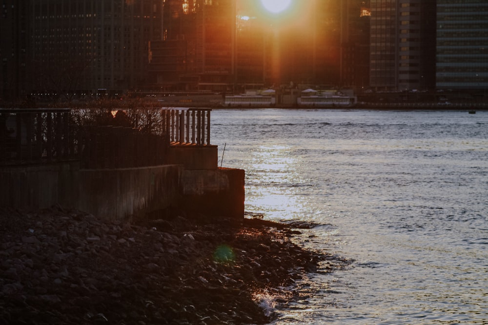 a body of water with a city in the background