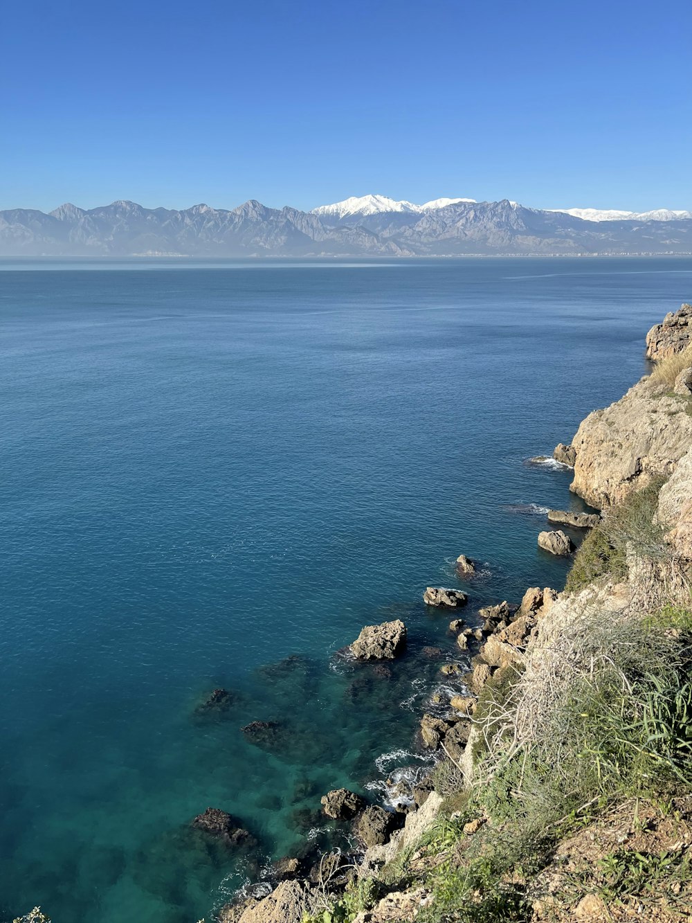 a body of water with mountains in the background