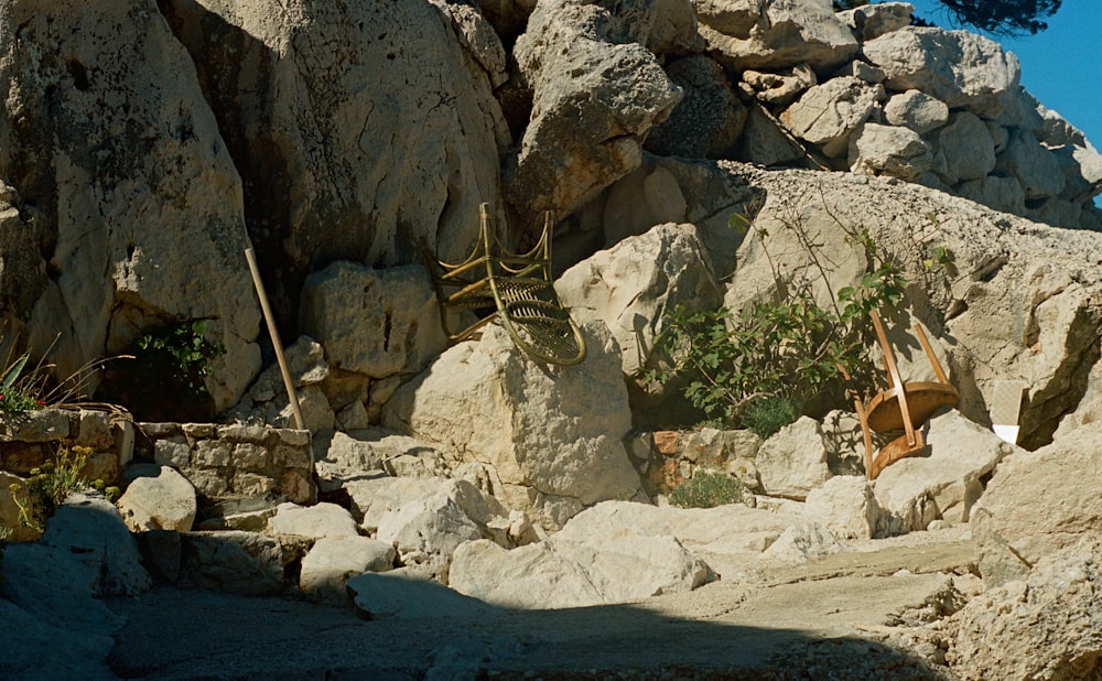 a chair sitting on top of a pile of rocks