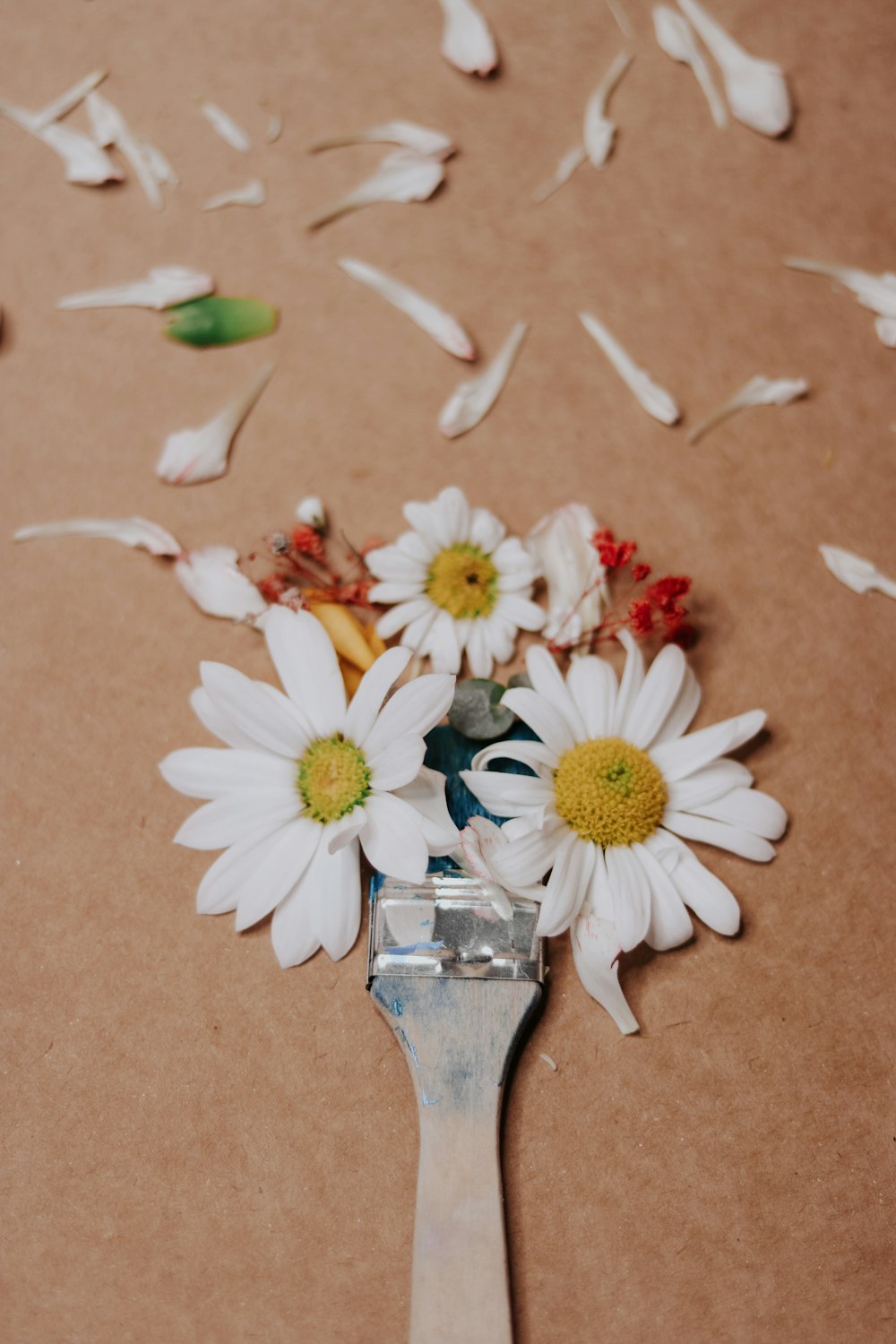 a close up of a spoon with flowers on it