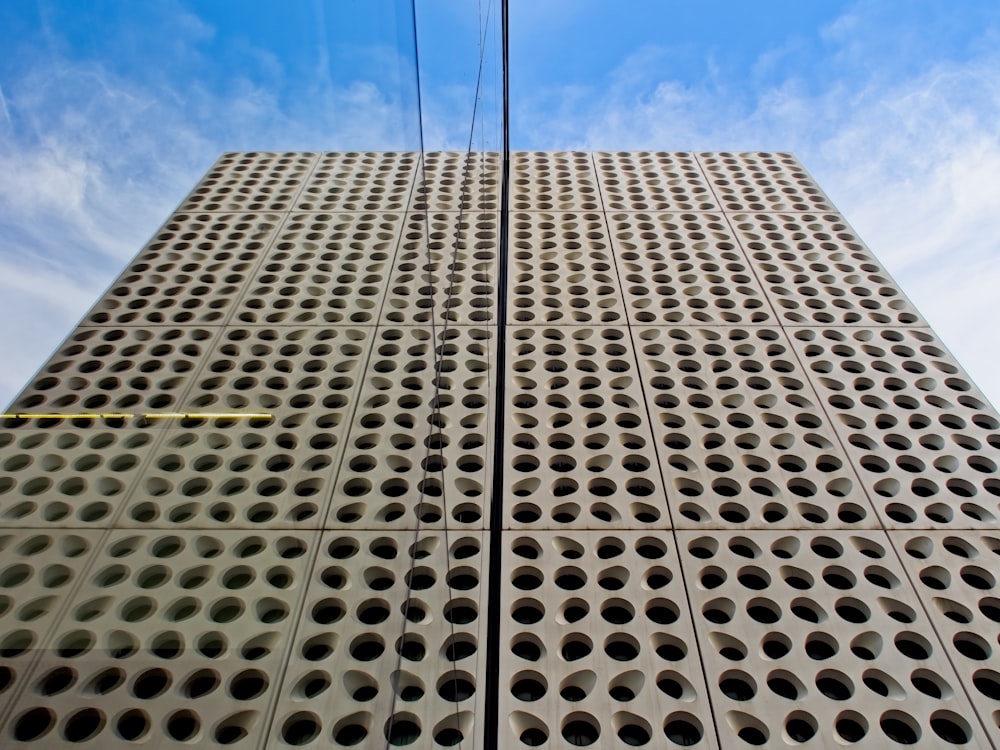 a tall building with holes on the side of it