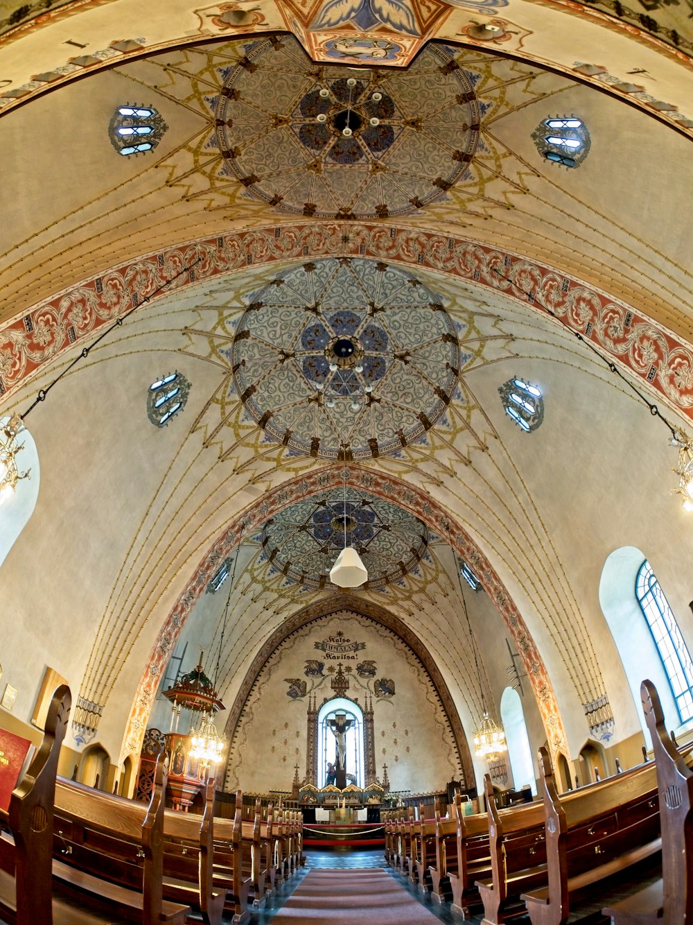 a church with a very high ceiling and a lot of pews