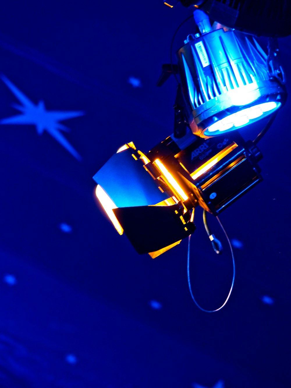 a close up of a blue light with stars in the background