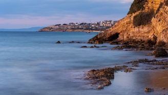 a view of the ocean with a city in the distance