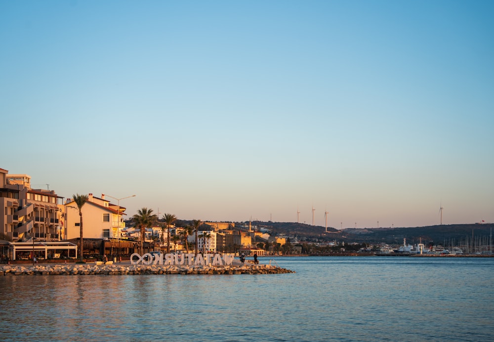 a large body of water with buildings on the shore