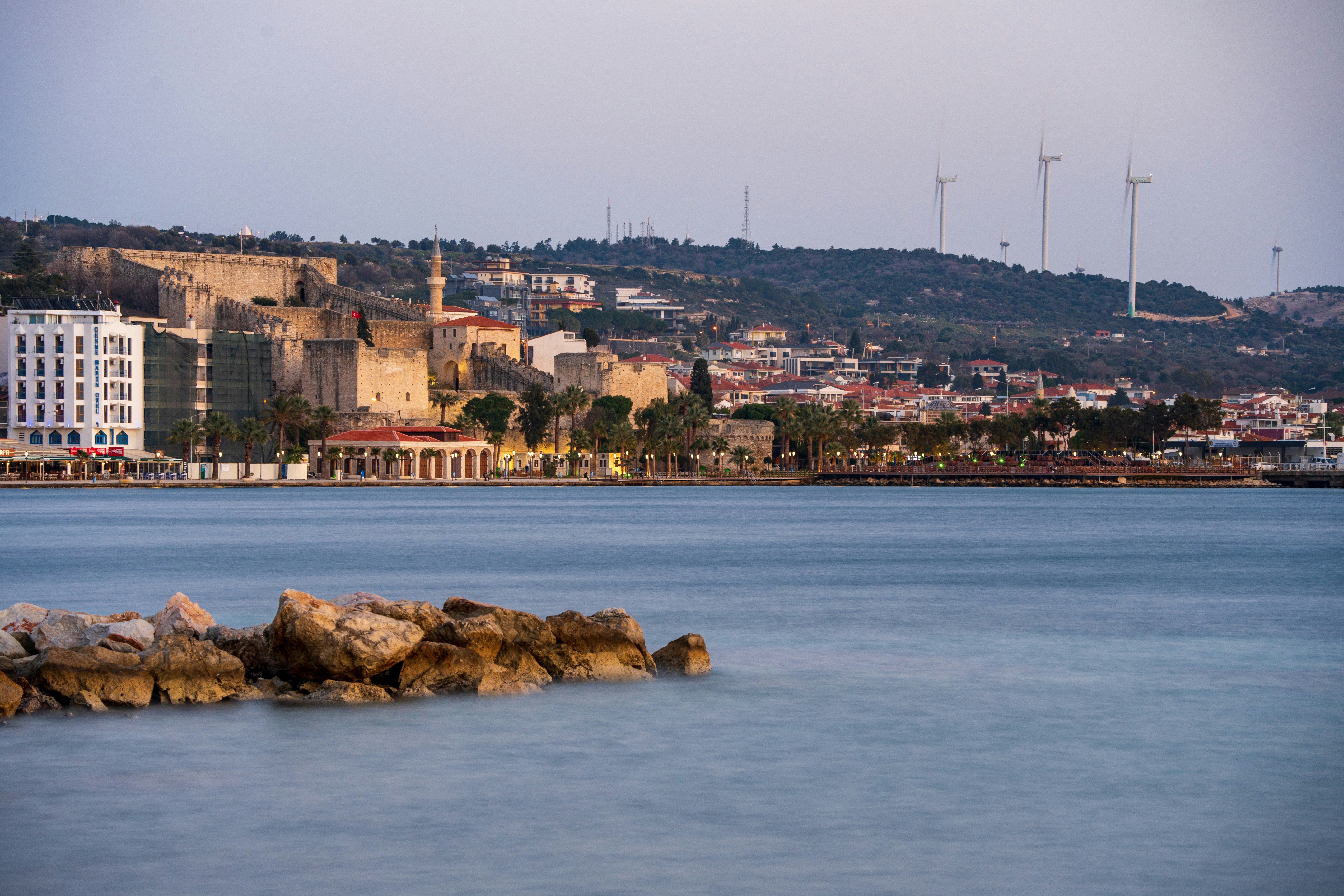 a body of water with a city in the background, 