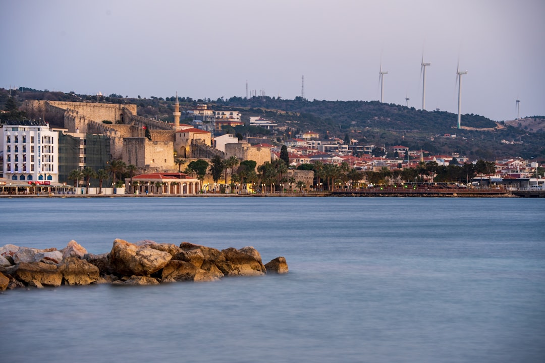 a body of water with a city in the background,
