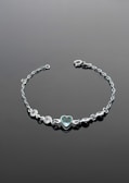 Elegant silver bracelet adorned with gemstones.