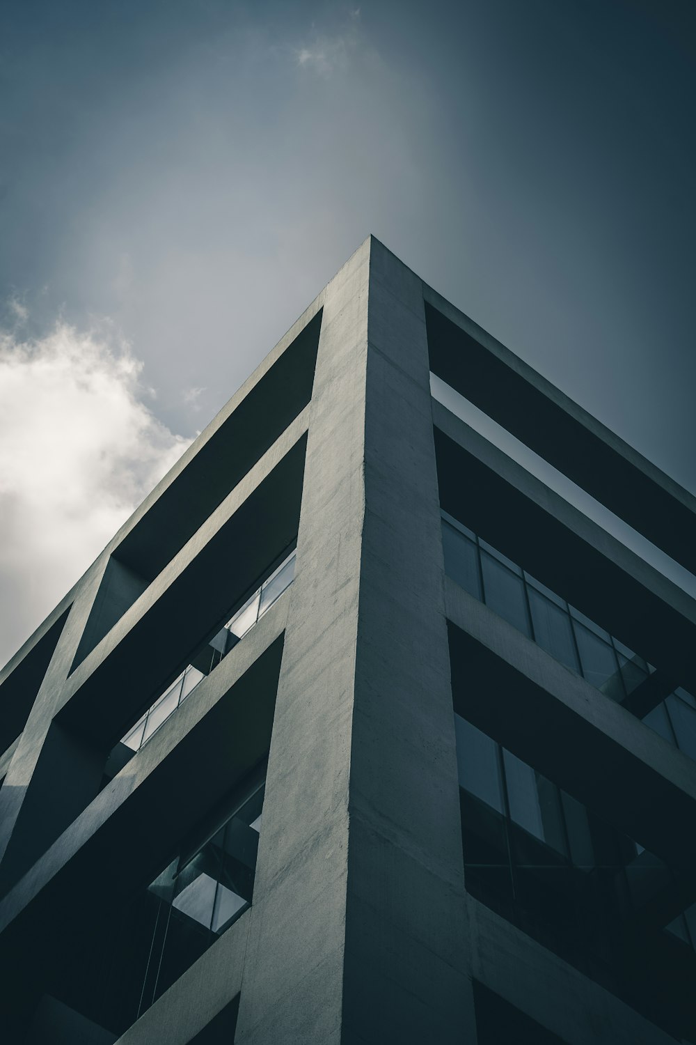 a tall building with windows and a sky background