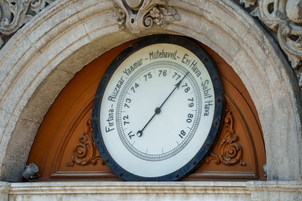 a large clock mounted to the side of a building