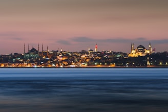 An elegant hotel suite with panoramic views of Istanbul’s skyline at dusk.