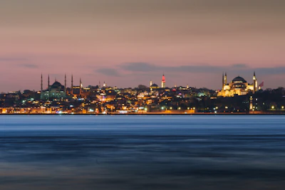 A sleek, modern Istanbul skyline at dusk, highlighting contemporary architecture with deep navy and slate grey tones.