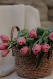 Bright and colorful artificial tulips arranged in a rustic basket.
