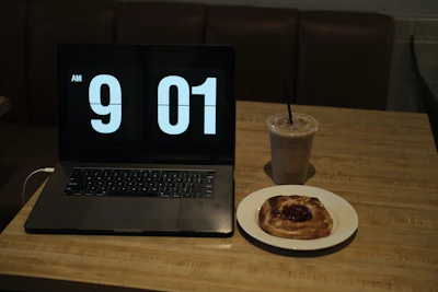 An early morning scene of a reporter typing notes on a laptop in a cozy café.