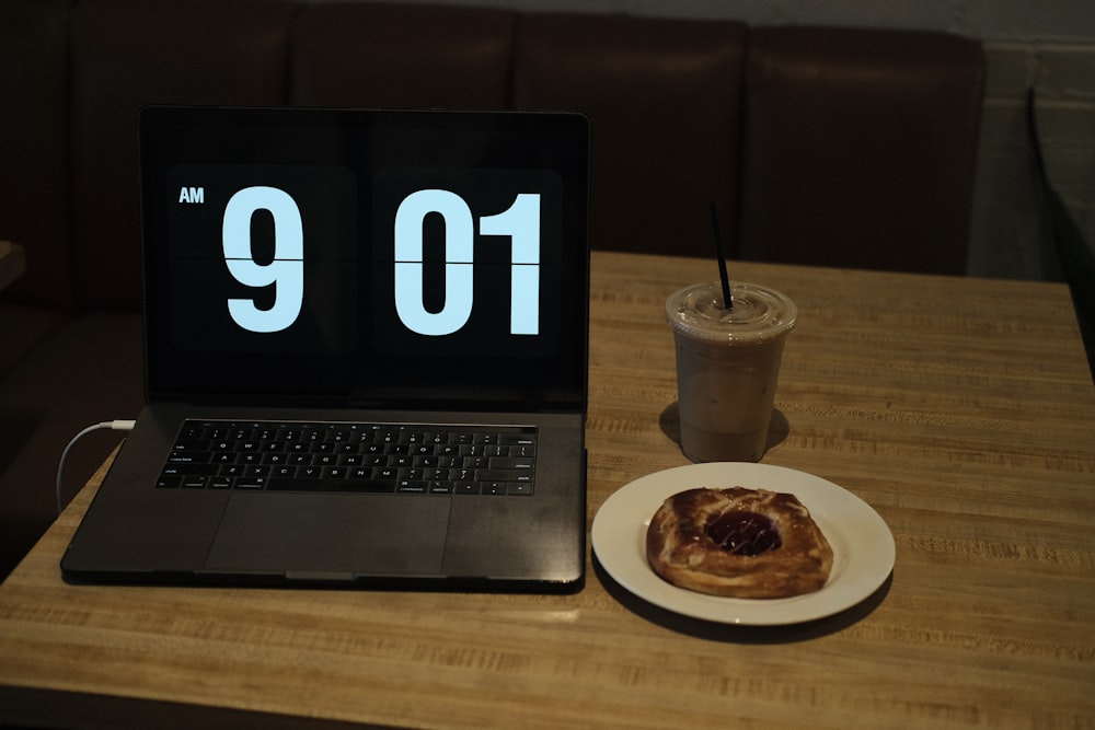 a laptop computer sitting on top of a wooden table