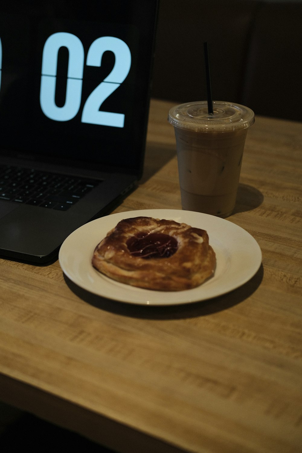 a plate of food next to a laptop on a table