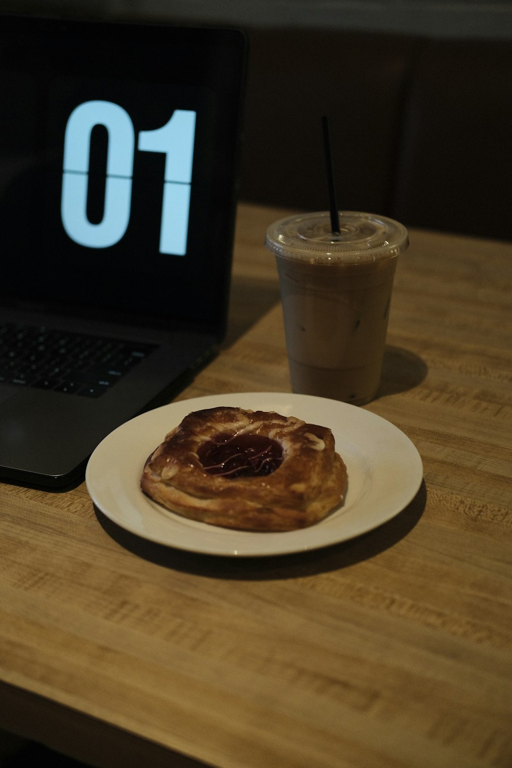 a plate of food next to a laptop on a table