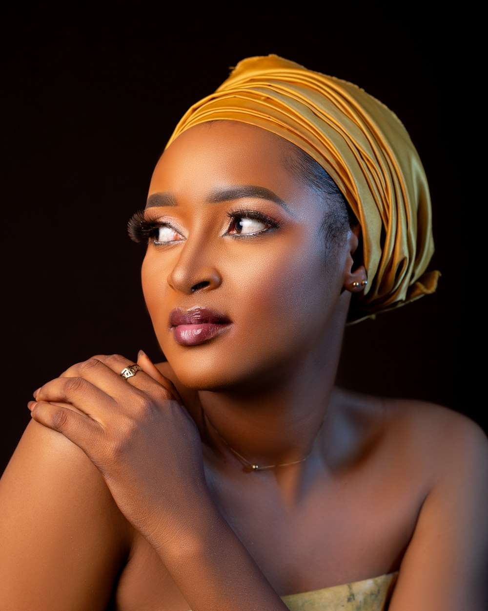 a woman with a yellow turban on her head