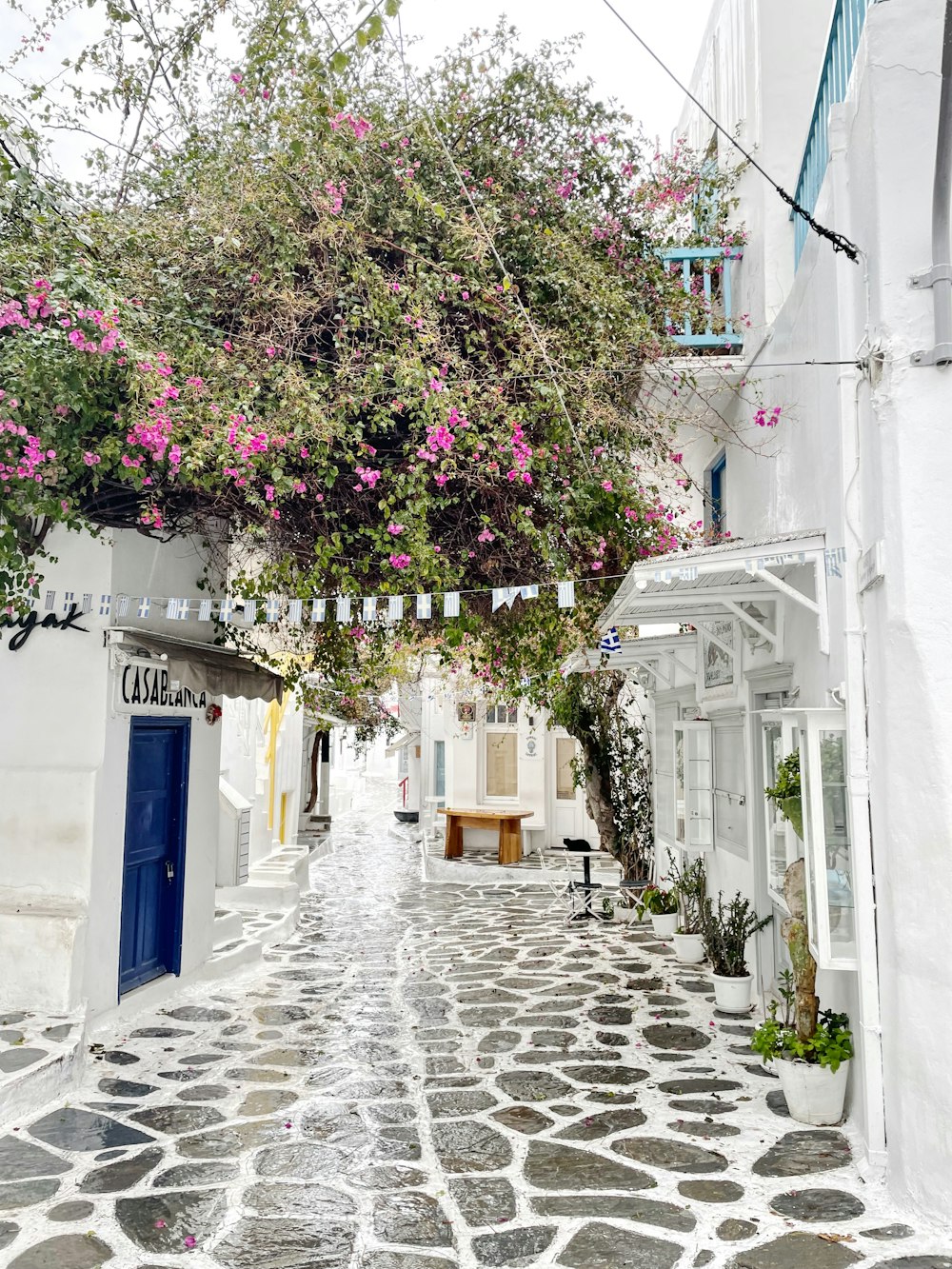 a cobblestone street lined with white buildings