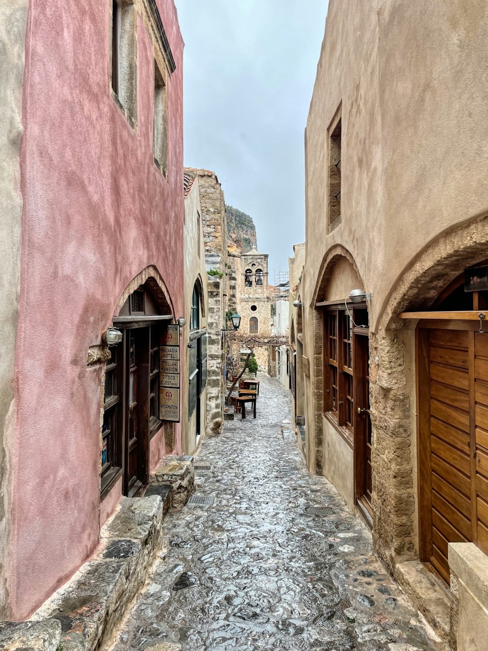 a narrow street with a few buildings on both sides