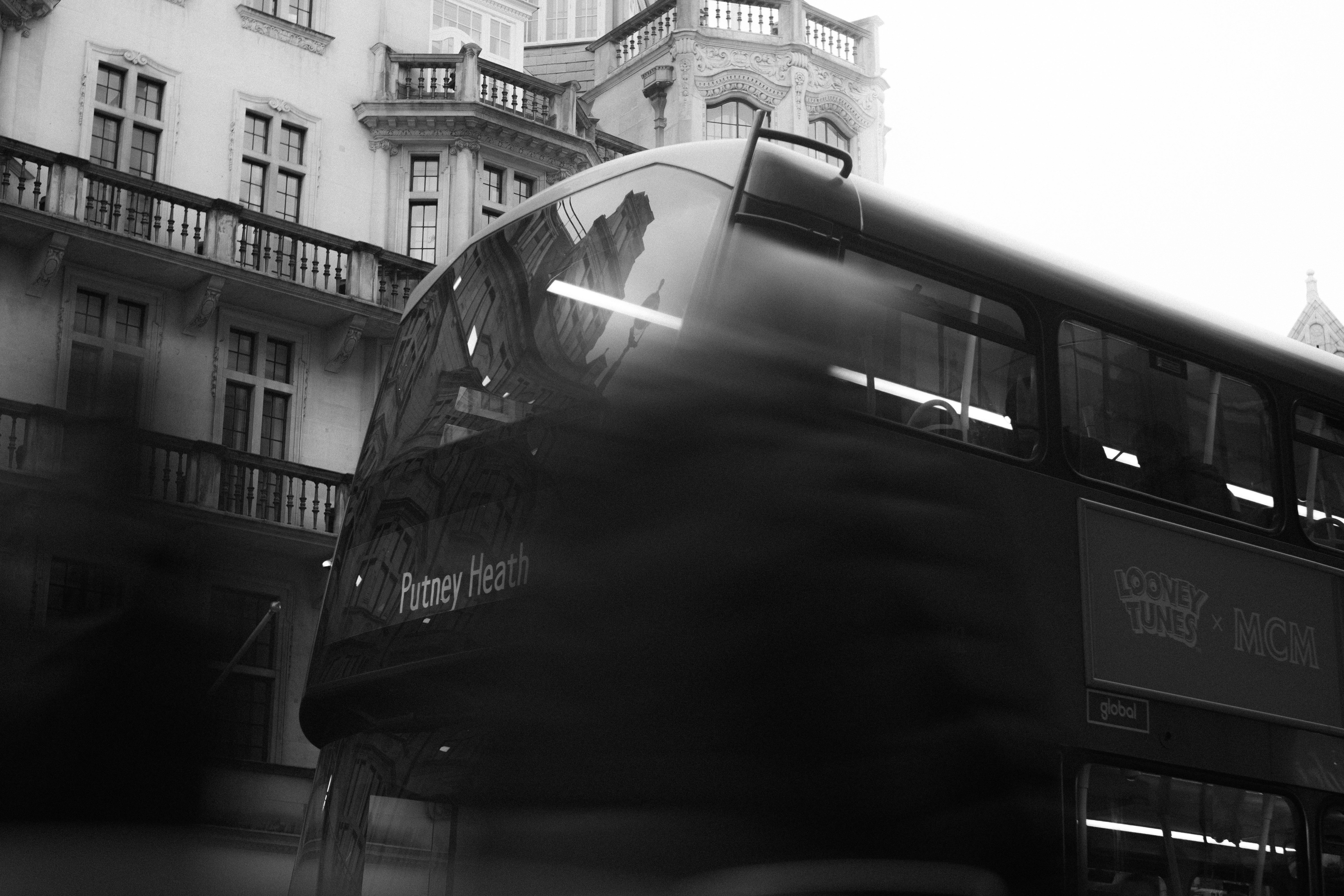 a black and white photo of a double decker bus