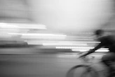 a blurry photo of a person riding a bike