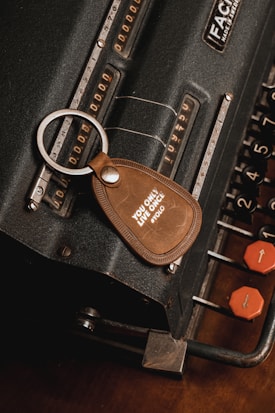 a keychain with a leather tag attached to it