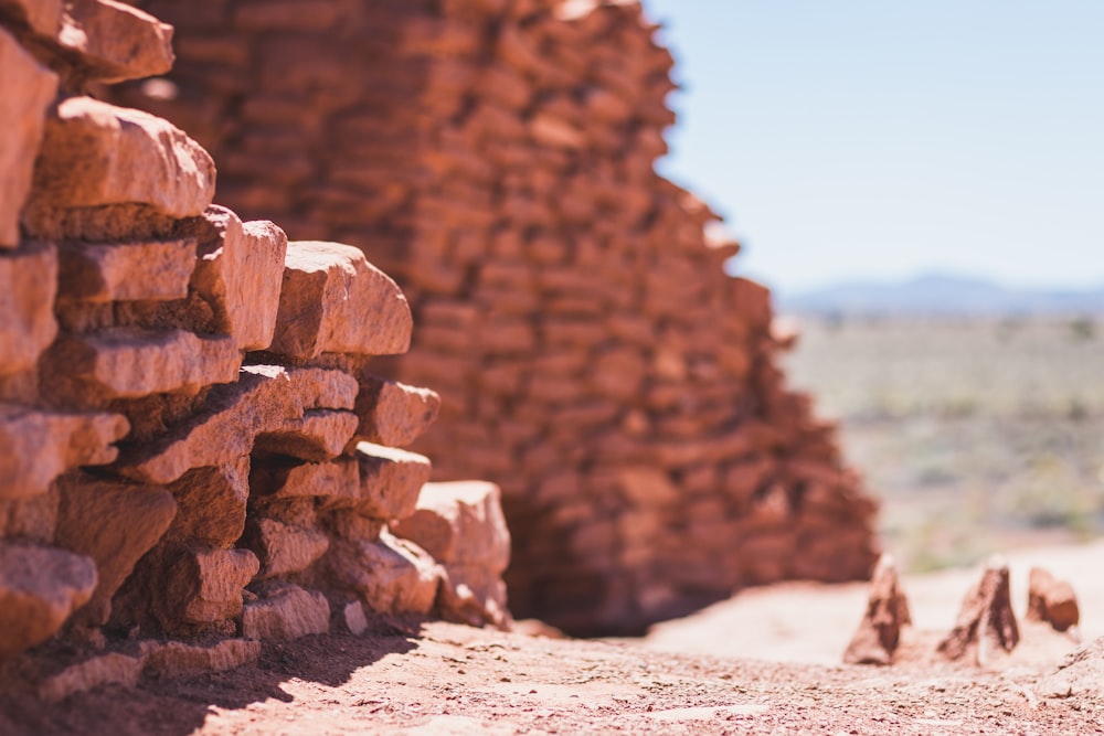 a pile of bricks sitting on top of a dirt field