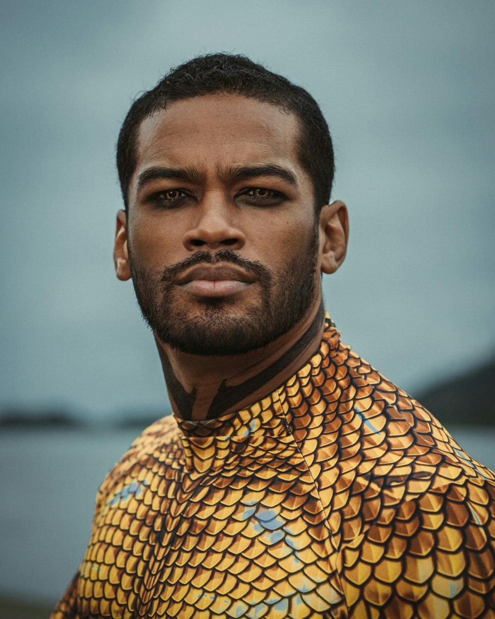 a man wearing a yellow and black shirt